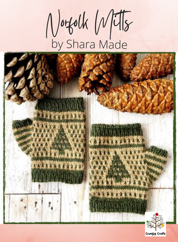 A pair of knitted Norfolk Mitts displayed alongside pine cones, with a decorative pattern featuring geometric